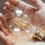 Sellable Plan - Unrecognizable woman demonstrating light bulb in hands