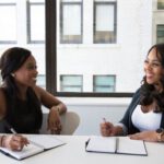 Business Planning Tips - Two Woman in Black Sits on Chair Near Table