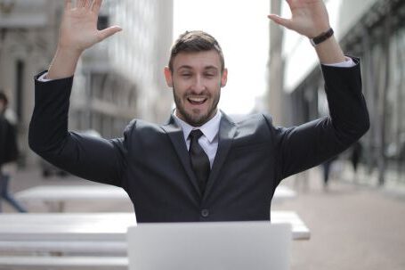 Business Success - Man in Black Suit Raising Both Hands