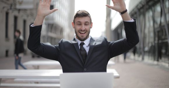 Business Success - Man in Black Suit Raising Both Hands